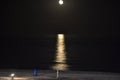 The moon rising over the horizon of the Mediterranean Sea. Photo taken from the shore of BenicÃÂ ssim beach Royalty Free Stock Photo